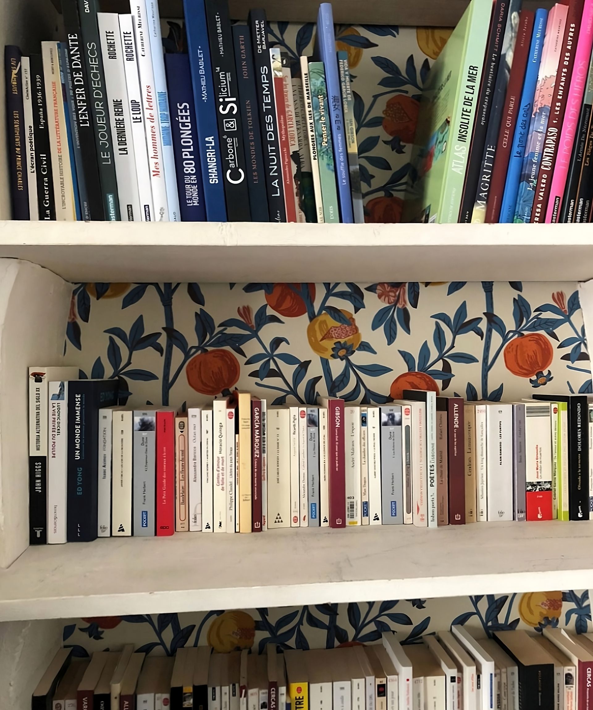 Bücherregal mit traditioneller gemusterter Tapete an der Rückwand, für einen charmanten und individuellen Dekorationsstil.
